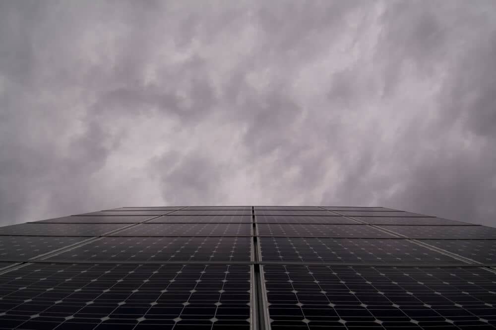 solar panels under a cloudy sky