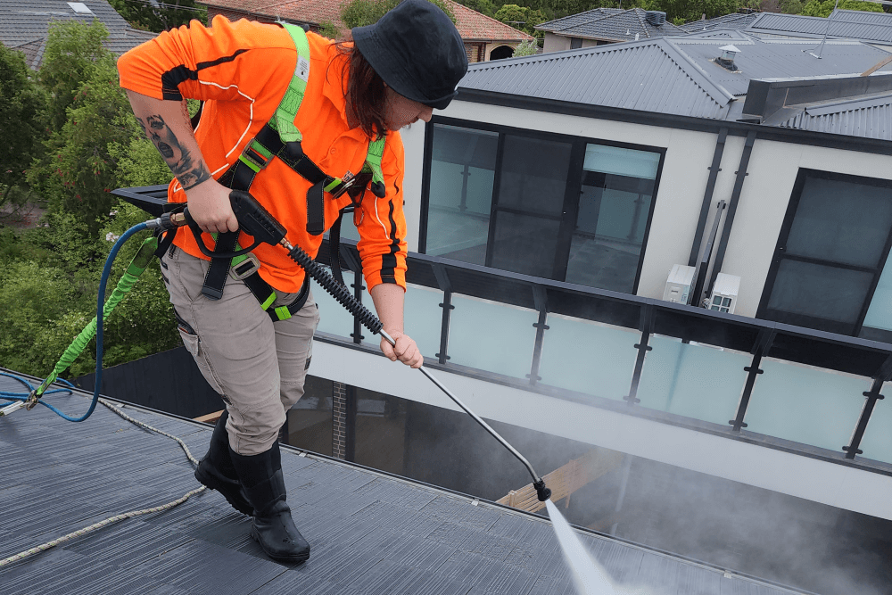 OBMG worker pressure washing cleaning strata roof